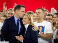 Rafał Trzaskowski, choć nie znamy jego dokładnego wieku, czule całuje żonę na tle tłumu.
