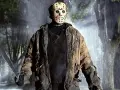 Jason Voorhees, ikona horrorów, w swojej zniszczonej kurtce i z maczetą, stoi w deszczu.