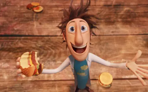 Flint Lockwood trzyma nadgryzionego hamburgera, podczas gdy wokół niego spadają klopsiki i inne zjawiska pogodowe.