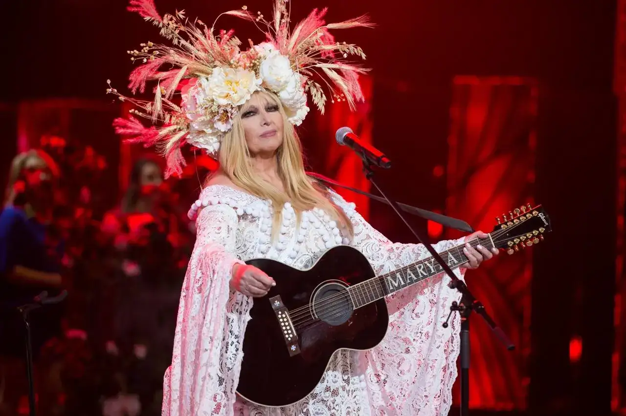 Maryla Rodowicz w koronkowej kreacji i wianku z kwiatów gra na gitarze. Niezależnie od tego, ile lat ma Maryla Rodowicz, wciąż zachwyca na scenie.