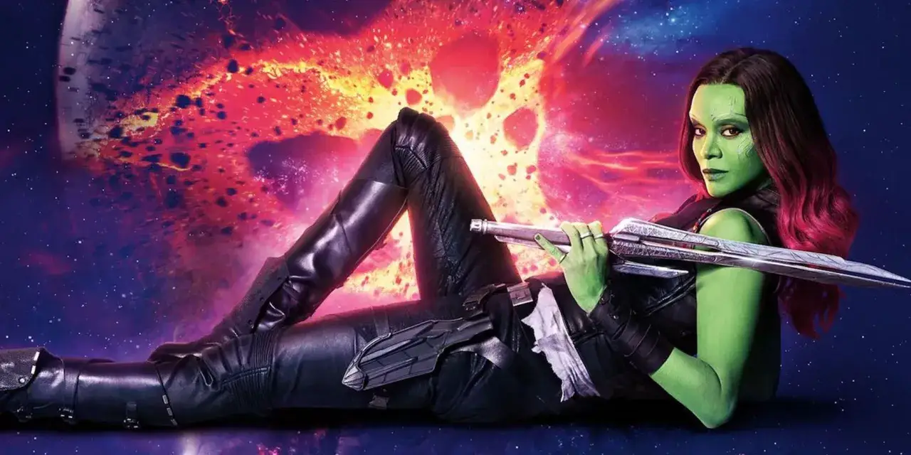 Gamora, zielonoskóra wojowniczka, odpoczywa z mieczem w dłoni na tle kosmicznej mgławicy.